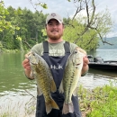 Colt Brewer holding two bass