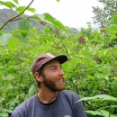 bearded man in USFWS hat among plants