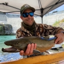 Photo of Jason Romine holding a large Bull Trout.