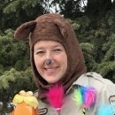 woman in bear costume holds decorations