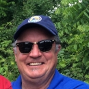 Staff photo of Mike Millard wears sunglasses and hat
