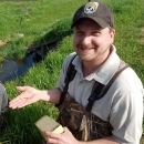 Nick Utrup, USFWS biologist is holding a Topeka shiner, a species of cyprinid freshwater fish. 