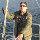 man standing on the deck of a boat