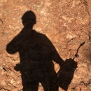 Silhouette of man holding fire equipment