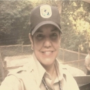 Sandra smiles in FWS baseball cap and polo