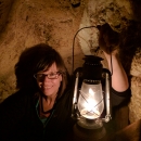 Tina Shaw holds a lantern during a cave tour