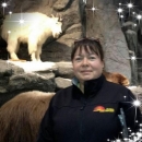 woman from waist up, standing in front of Mountain Goat museum display