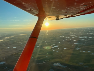 View from an airplane of the sunrise over the landscape