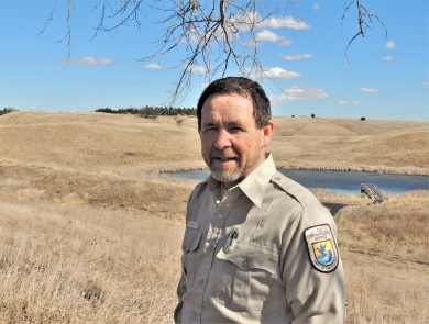 Martin Baker surrounded by native and reconstructed prairie