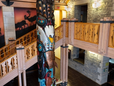 Totem Pole displayed in front of wood carved steps