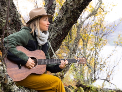 musician KT Tunstall plays guitar in a tree