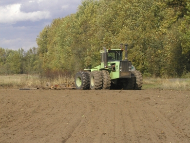 A tractor works the ground at a Willamette Valley Refuge