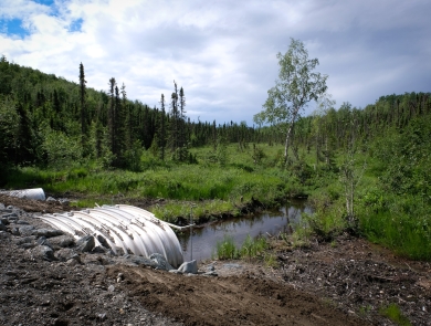 A new culvert extends beneath a road in Wasila, AK, to improve fish passage for salmon.