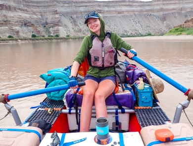Woman rowing raft on Green River in Utah 