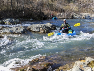 a person kayaking in rapids