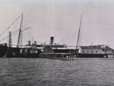And old black and white photo of a ship and Blackbeard wharf.