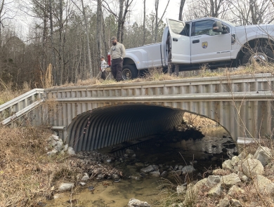 Service biologists examine the arched bottomless culvert at Smith Creek in Calhoun County, Mississippi.