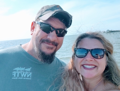 Ronald & Carrie taking selfie with ocean behind them.