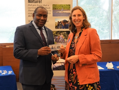 U.S. Fish and Wildlife Service Director Martha Williams purchases a 2022-2023 Federal Duck Stamp with Assistant Director, Migratory Bird Program, Jerome Ford.