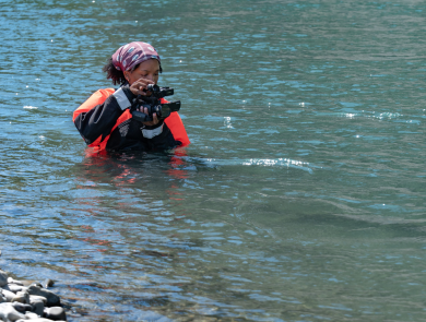 USFWS intern, Typhanie Shepherd, filming on the Elwha River in her drysuit.