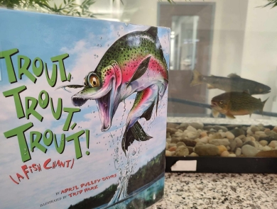 Trout children's book displayed in front of tank