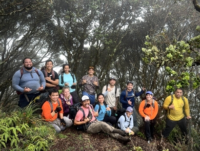 Staff from Oʻahu Army Natural Resources Program and Pacific Islands Fish and Wildlife Office stand amongst ʻohiʻa lehua trees
