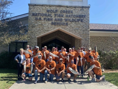 Group of people holding fish