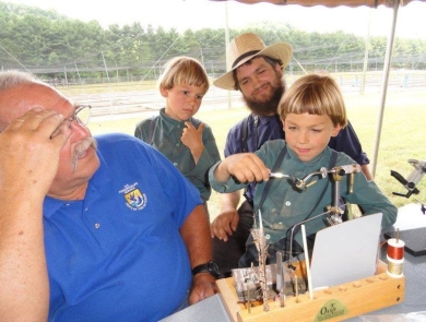 Children learning to make flies