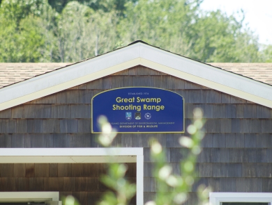 Blue welcome sign at over the shooting range
