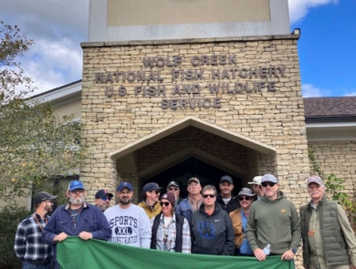 Group posing with banner
