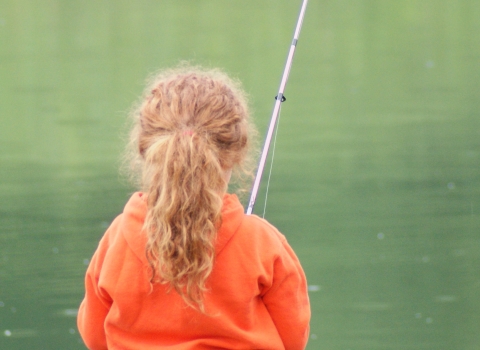 An image of a small child fishing.