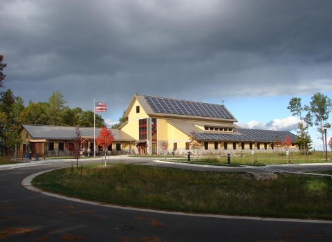 Necedah's visitor center in fall with a stormy sky