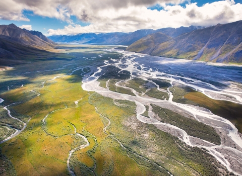 Striking aerial photo of a river bed running between mountain ranges in Alaska.