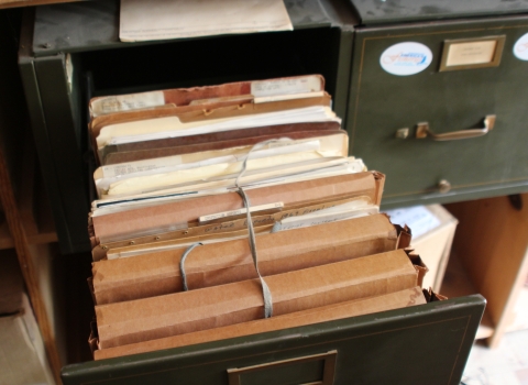 Bundled files in an old filing cabinet.