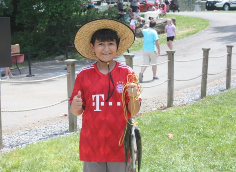 child holding a stringer of trout