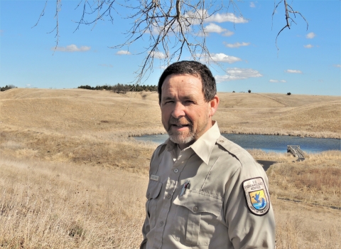 Martin Baker surrounded by native and reconstructed prairie