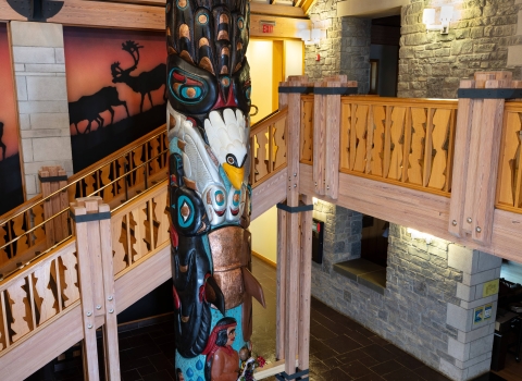totem pole displayed in front of wood carved steps