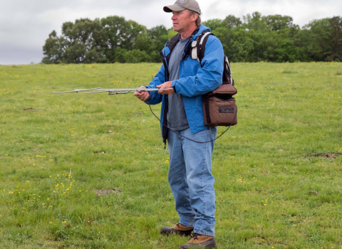 Volunteer Tom Ress holds radio telemetry equipment as he tracks cranes in Wheeler National Wildlife Refuge. 