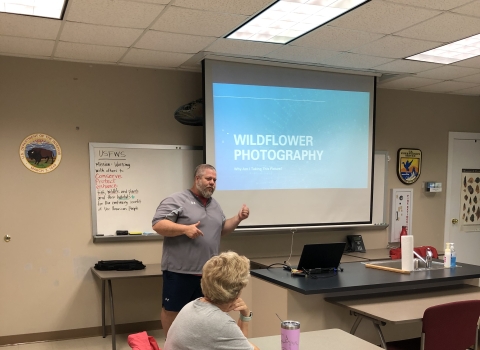 Man giving slideshow presentation in classroom
