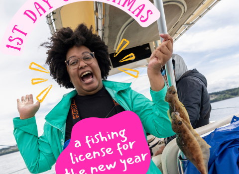 A person with a huge grin on their face stands in waders on a boat holding fish. Text on image reads "1st Day of Fishmas, a fishing license for the new year."