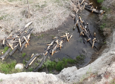 A stream from above filled with bundles of logs