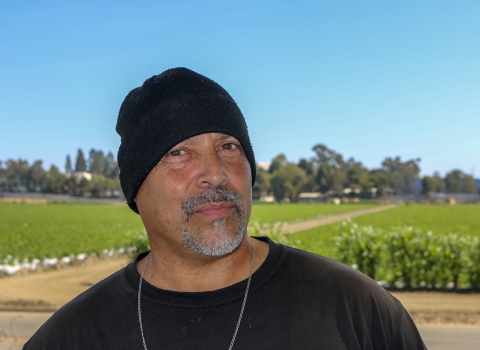 A man wearing a black beanie and black shirt