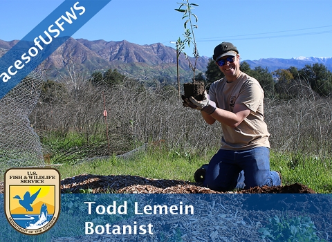 A man holding a plant above a hole. A banner reads "#FacesofUSFWS". Another banner reads "Todd Lemein, Botanist"