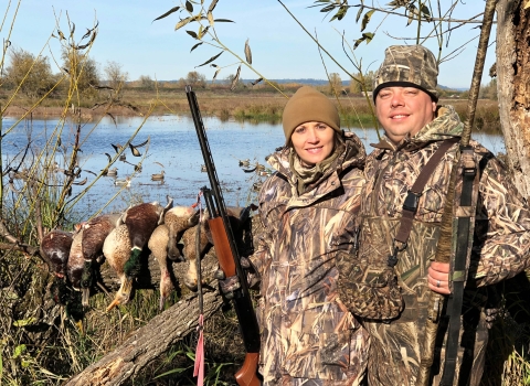 Man and woman waterfowl hunting