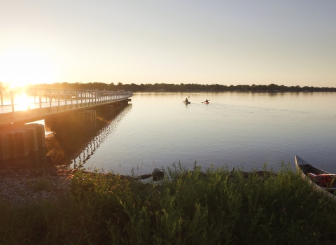 The setting sun shines on a new fishing pier at Detroit River International Wildlife Refuge.