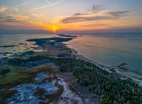 Aerial view of Waugoshance Point in Wilderness State Park on Lake Michigan at sunset in winter.